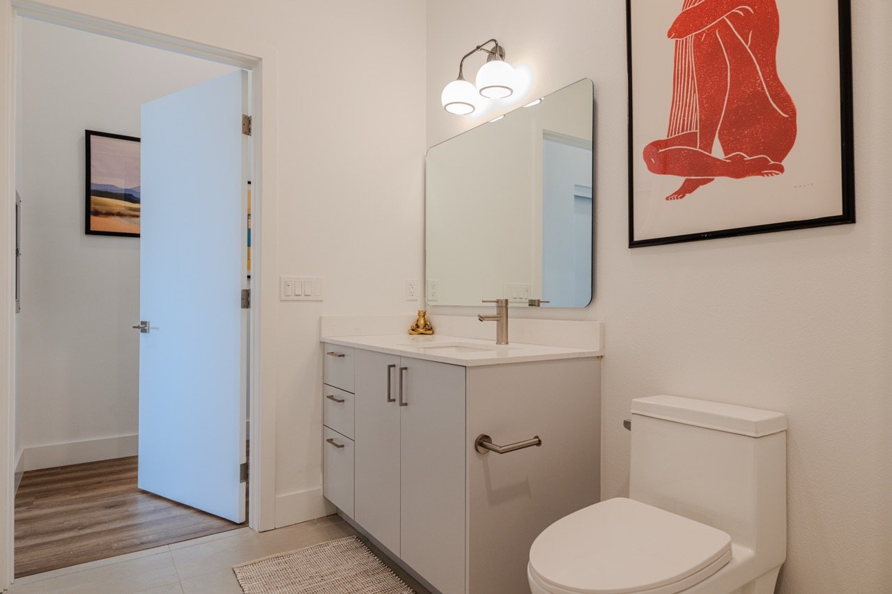 Handleless white frameless bathroom vanity with a quartz countertop