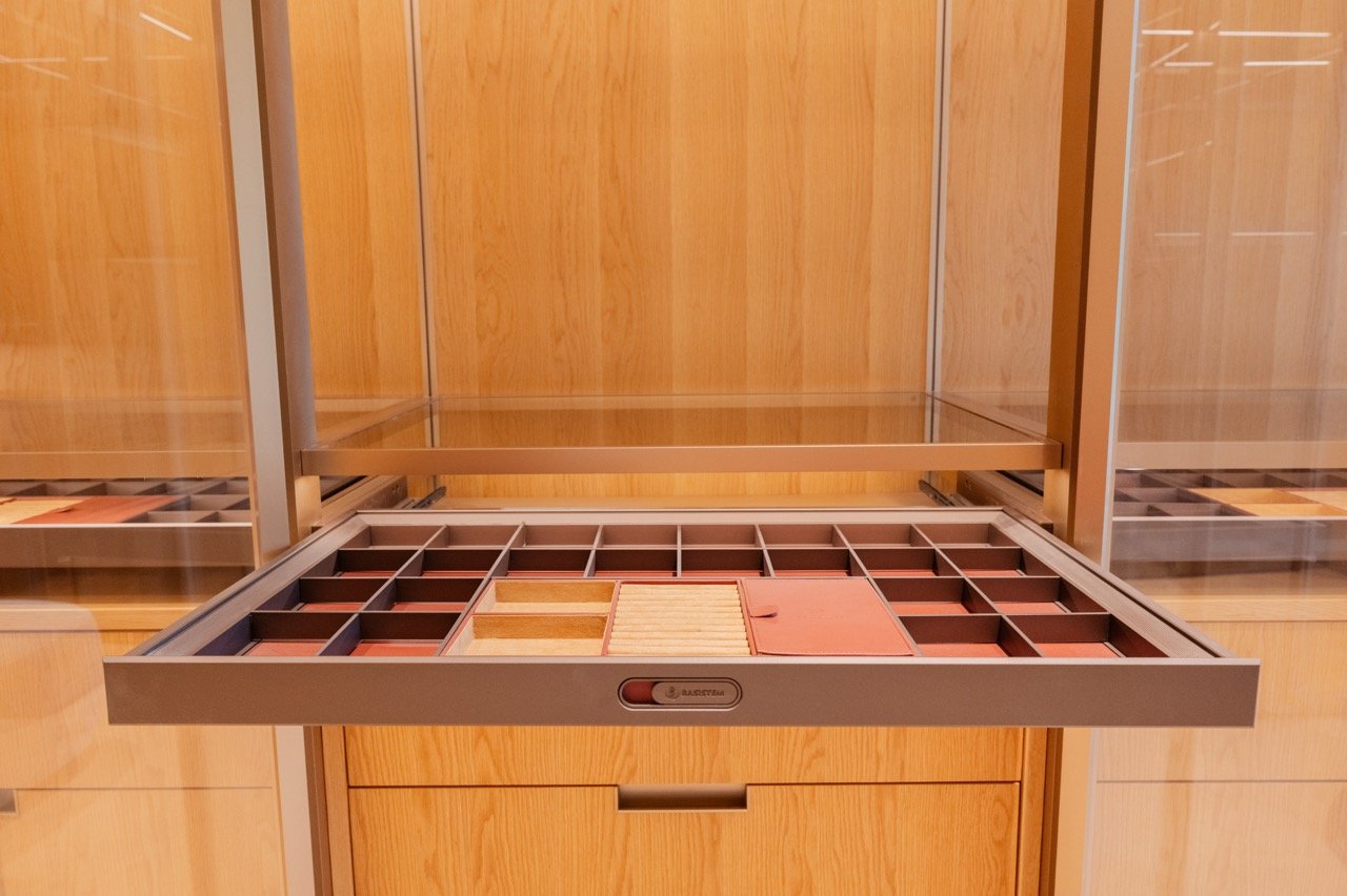 Two-tone handleless European kitchen with white uppers and woodgrain base cabinets