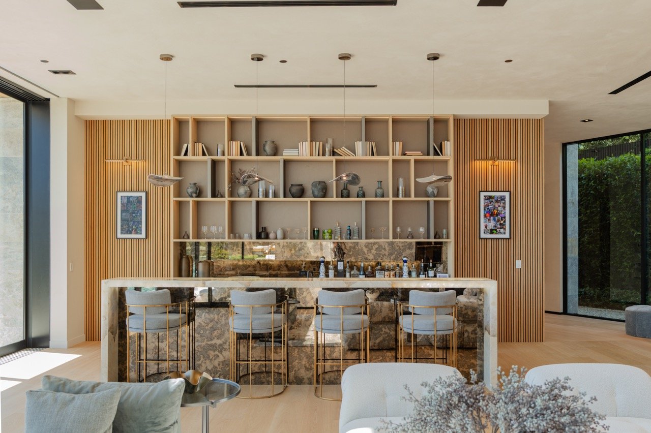Bar with open oak grid shelving, stone counter and slatted wall panelling