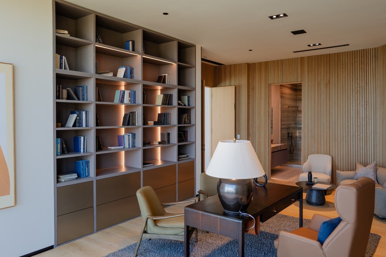 Study bookcase with integrated lighting over deep drawer storage