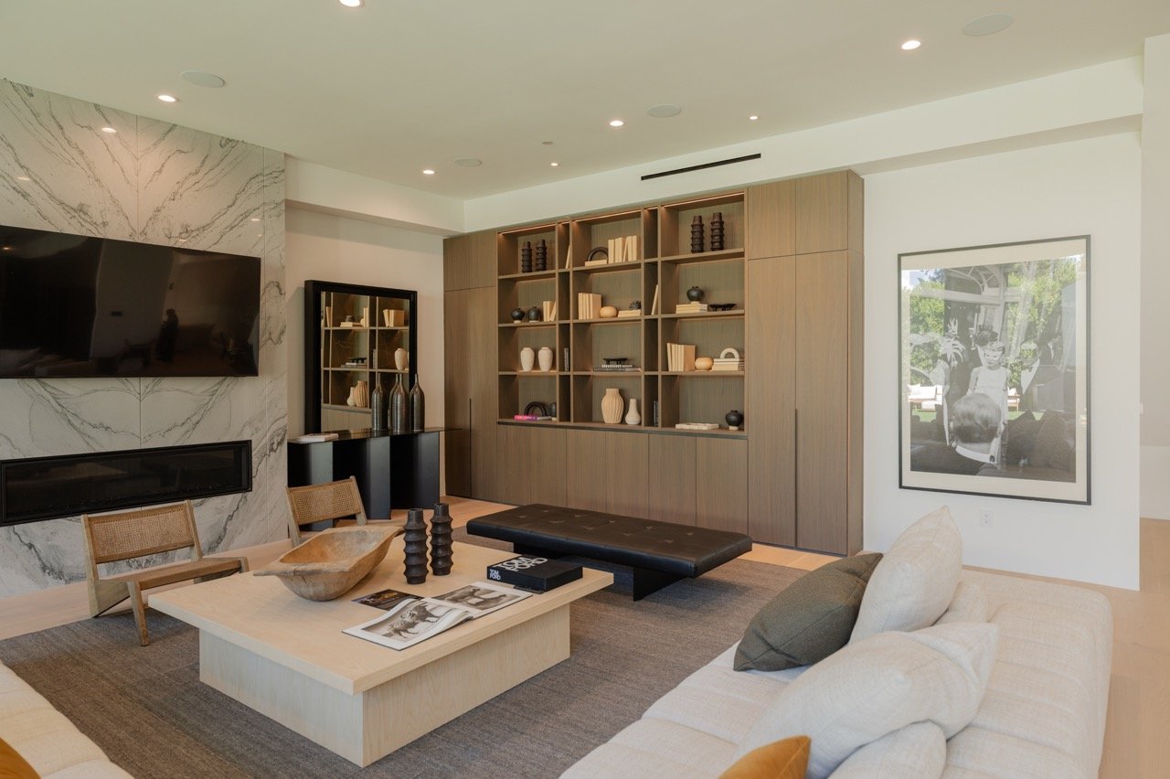 Living room built-in with open display, closed base storage and a marble surround